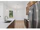 Well-lit kitchen with stainless steel appliances, center island, and view of dining area at 4661 Forlano Cir, North Port, FL 34291