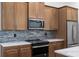 Modern kitchen featuring stainless steel appliances, stylish cabinets, and a sleek backsplash, combining functionality with design at 4661 Forlano Cir, North Port, FL 34291
