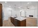 Bright, open kitchen and living area with a large island, wood floors and recessed lighting at 4661 Forlano Cir, North Port, FL 34291