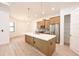 Modern kitchen with large island, stainless appliances, and wood cabinets at 4661 Forlano Cir, North Port, FL 34291