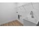 Well-lit laundry room with sink and wire shelf at 4661 Forlano Cir, North Port, FL 34291