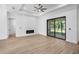Modern living room with plank floors, tray ceiling, fireplace and large sliding door for natural light at 4661 Forlano Cir, North Port, FL 34291