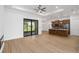 Open-concept living room, kitchen with breakfast bar, recessed lights, and sliding glass door to screened in porch at 4661 Forlano Cir, North Port, FL 34291
