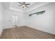 Bright and airy main bedroom with wood floors, tray ceiling, ceiling fan, and side window at 4661 Forlano Cir, North Port, FL 34291