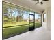 View from screened-in patio of the green backyard and adjacent houses at 4661 Forlano Cir, North Port, FL 34291