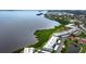 Aerial view of waterfront condos and a tranquil pond surrounded by lush greenery in a coastal community at 4745 Independence Dr # 4745, Bradenton, FL 34210