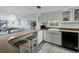 Charming kitchen with white cabinets, a farmhouse sink, and barstool seating at 4745 Independence Dr # 4745, Bradenton, FL 34210