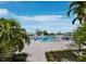 Community pool surrounded by palm trees and lounge chairs at 4745 Independence Dr # 4745, Bradenton, FL 34210