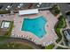 An aerial view of a community pool with lounge chairs and manicured landscaping at 4745 Independence Dr # 4745, Bradenton, FL 34210