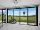 Relaxing view of the water from the living area with sliding glass doors and an open patio area at 4745 Independence Dr # 4745, Bradenton, FL 34210