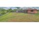 Lush backyard with a tranquil pond view and screened patio, creating a serene outdoor space at 5004 32Nd E St, Bradenton, FL 34203