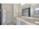 Bathroom with a large mirror, a white vanity with ample counter space and storage, and a shower-tub combination at 5004 32Nd E St, Bradenton, FL 34203