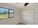 Bedroom featuring carpet flooring, a ceiling fan, closet and a bright window with pond view at 5004 32Nd E St, Bradenton, FL 34203