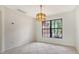 Bright dining area featuring tile flooring, a stylish chandelier, and a large window with exterior views at 5004 32Nd E St, Bradenton, FL 34203