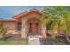 Charming front entrance featuring a brick archway, well-kept landscaping, and unique architectural details at 5004 32Nd E St, Bradenton, FL 34203