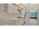 Clean kitchen features white cabinetry and stainless appliances at 5004 32Nd E St, Bradenton, FL 34203