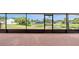 Enclosed lanai offers a serene view of the pond at 5004 32Nd E St, Bradenton, FL 34203