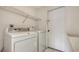 Functional laundry room with a washer, dryer, and a storage shelf at 5004 32Nd E St, Bradenton, FL 34203