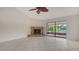 Bright living room showcasing tile floors, a stone fireplace, and sliding glass doors to the screened lanai at 5004 32Nd E St, Bradenton, FL 34203