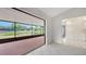 Bright living room featuring white tile flooring, and access to the screened-in patio with a pond view at 5004 32Nd E St, Bradenton, FL 34203