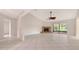 Spacious living room featuring tile floors, a cozy fireplace, and sliding glass doors to the lanai at 5004 32Nd E St, Bradenton, FL 34203