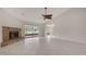 Open living space with tile floors, a fireplace, access to additional rooms, and sliding glass doors to patio at 5004 32Nd E St, Bradenton, FL 34203