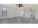 Main bedroom features gray laminate flooring, a ceiling fan, and ensuite bathroom at 5004 32Nd E St, Bradenton, FL 34203
