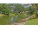 Scenic pond view with mature trees, landscaping, and wildlife creating a tranquil setting at 5004 32Nd E St, Bradenton, FL 34203