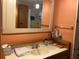 Bathroom featuring a sink with a mirror and storage cabinets at 5268 Boca Raton Ave, Sarasota, FL 34234