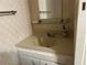 Simple bathroom with a vanity and a mirror, with neutral colors at 5268 Boca Raton Ave, Sarasota, FL 34234