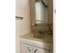 Classic bathroom design with a vanity, mirror, and neutral wallpaper at 5268 Boca Raton Ave, Sarasota, FL 34234
