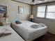 Bright bedroom with a double bed, lamps and minimalist decor, creating a peaceful space at 5268 Boca Raton Ave, Sarasota, FL 34234