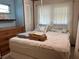 Inviting bedroom with soft natural light and a comfortable-looking, inviting bed at 5268 Boca Raton Ave, Sarasota, FL 34234