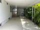 Spacious carport featuring ample covered parking and mature tropical foliage at 5268 Boca Raton Ave, Sarasota, FL 34234