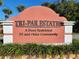 Entrance sign for Tri-Par Estates, a deed-restricted 55 and older community, surrounded by lush landscaping at 5268 Boca Raton Ave, Sarasota, FL 34234