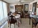 Dining area with a wooden china cabinet, a ceiling fan and colorful tablecloth at 5268 Boca Raton Ave, Sarasota, FL 34234
