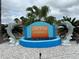 Community entrance featuring a decorative dolphin fountain and the Tri-Par Estates sign at 5268 Boca Raton Ave, Sarasota, FL 34234