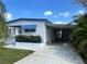 Charming single-story home with blue trim, a covered awning, and a well-maintained yard at 5268 Boca Raton Ave, Sarasota, FL 34234