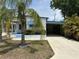 Charming single-story home with a covered carport, lovely landscaping, and a welcoming front porch at 5268 Boca Raton Ave, Sarasota, FL 34234