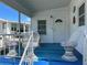 Inviting front porch with seating, blue accents, and a charming entry door at 5268 Boca Raton Ave, Sarasota, FL 34234