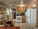 Well-lit kitchen with white appliances and wooden cabinets adjacent to a cozy dining area at 5268 Boca Raton Ave, Sarasota, FL 34234