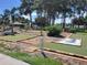 Outdoor miniature golf course surrounded by mature trees and landscaping at 5268 Boca Raton Ave, Sarasota, FL 34234