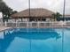 Community pool with a tiki hut, offering a perfect spot for relaxation and socializing in a tropical setting at 5268 Boca Raton Ave, Sarasota, FL 34234