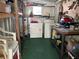Functional utility room featuring a washer, dryer, water heater, work bench, and shelving for convenient storage solutions at 5268 Boca Raton Ave, Sarasota, FL 34234