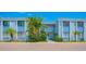 Charming condo building with blue accents and tropical landscaping, offering a serene living environment at 5310 26Th W St # 902, Bradenton, FL 34207