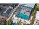 Aerial view of the pool area featuring an enclosed pool and connected stairwell, surrounded by tropical landscaping at 5385 Avenida Del Mare, Sarasota, FL 34242