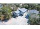 Aerial view of the house showing a well manicured yard, large driveway, and a screened-in pool at 5385 Avenida Del Mare, Sarasota, FL 34242