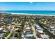 Aerial view of a beach house with a pool, surrounded by lush greenery and located near the beach at 5385 Avenida Del Mare, Sarasota, FL 34242