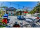 Charming backyard featuring a patio with an umbrella-covered table and chairs, with lush tropical landscaping at 5385 Avenida Del Mare, Sarasota, FL 34242