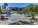 Outdoor patio area with chairs, umbrellas, landscaping, and a view of the screened-in pool at 5385 Avenida Del Mare, Sarasota, FL 34242